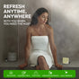 A woman enjoys a steamy shower with Fomin’s Shower Steamer - Melon Splash. "Refresh anytime, anywhere"—perfect for vacations, business trips, after workouts, or getaways. Experience aromatherapy with essential oil-infused steamers.