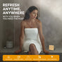 A woman in a white towel relaxes in a steamy bathroom. Text: Refresh anytime, anywhere with Fomin Shower Steamer - Spiced Orange. Aromatherapy icons highlight uses for vacations, gym, and daily refresh.