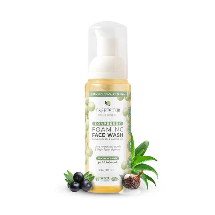A bottle of Tree To Tub Foaming Face Wash for Dry & Sensitive Skin with a white pump, surrounded by soapberry and aloe vera. This gentle cleanser is fragrance-free, pH balanced, and ideal for sensitive skin.