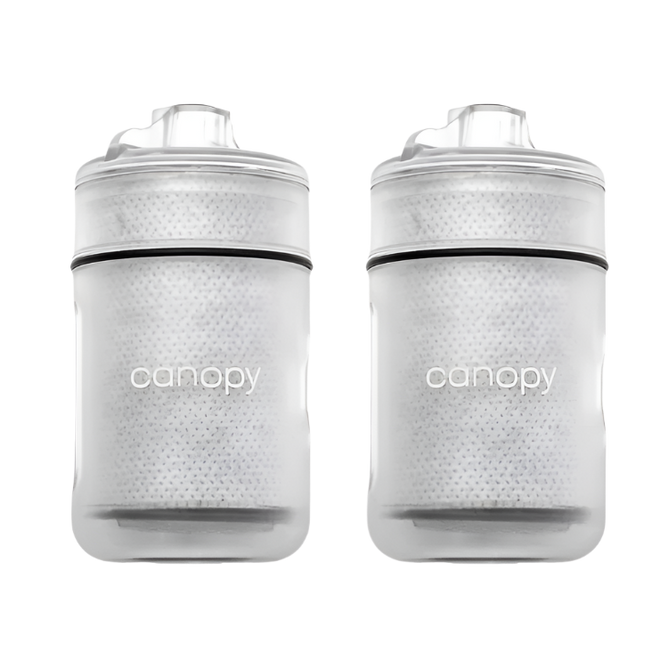 Two clear baby bottles with black accents and 'canopy' branding on a white background