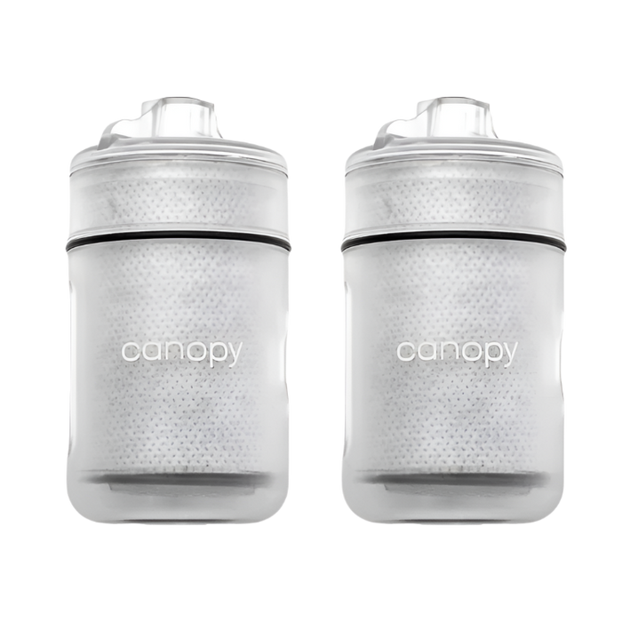 Two clear baby bottles with black accents and 'canopy' branding on a white background