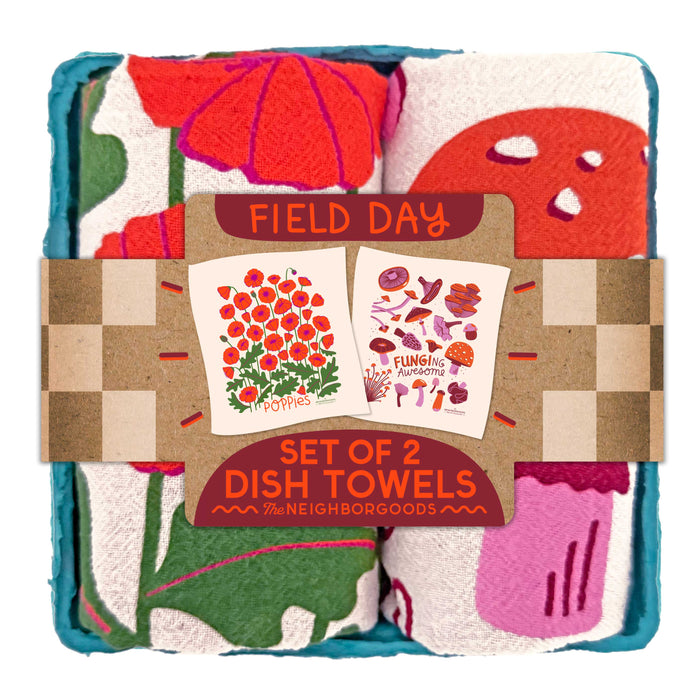 The Neighborgoods Dish Towel Set includes two colorful cotton towels with bold, embroidered poppies and mushrooms, wrapped in a FIELD DAY label—perfect for adding vibrant charm to your kitchen.