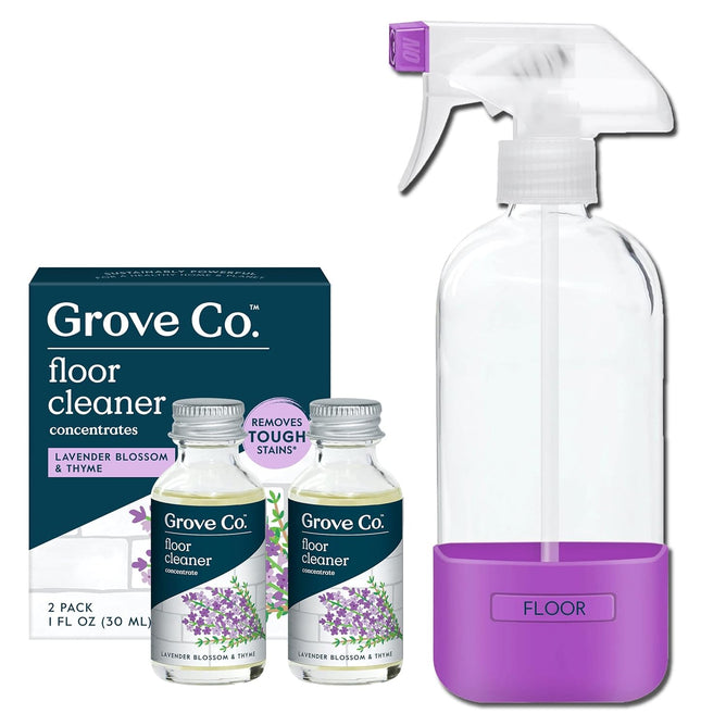 The Grove Co. Floor Cleaner Concentrate Starter Pack Bundle includes a reusable glass spray bottle with a purple label, two lavender blossom & thyme floor cleaner concentrate bottles, and a matching product box—ideal for laminate floors.