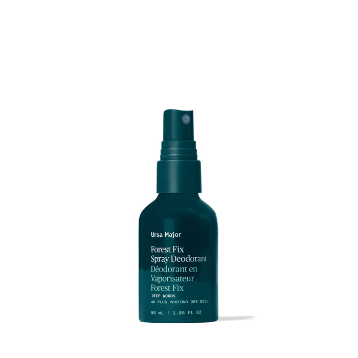 A dark green spray bottle labeled "Ursa Major Forest Fix Spray Deodorant" stands upright on a white background. This deodorant, powered by plant enzymes for odor defense, contains 55 ml (1.85 fl oz) of product.