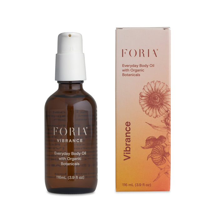 A brown glass bottle of Foria Vibrance Everyday Body Oil with Organic Botanicals (116 ml / 3.9 fl oz) stands next to its matching box, featuring botanical illustrations and orange accents. This oil is skin-soothing and ultra-moisturizing.