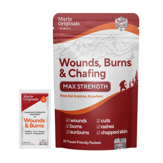 A pouch labeled Marie Originals Wounds, Burns & Chafing Ointment Packets with an individual packet in front. This salve supports skin regeneration for wounds, burns, cuts, sunburns, rashes, and chapped skin.