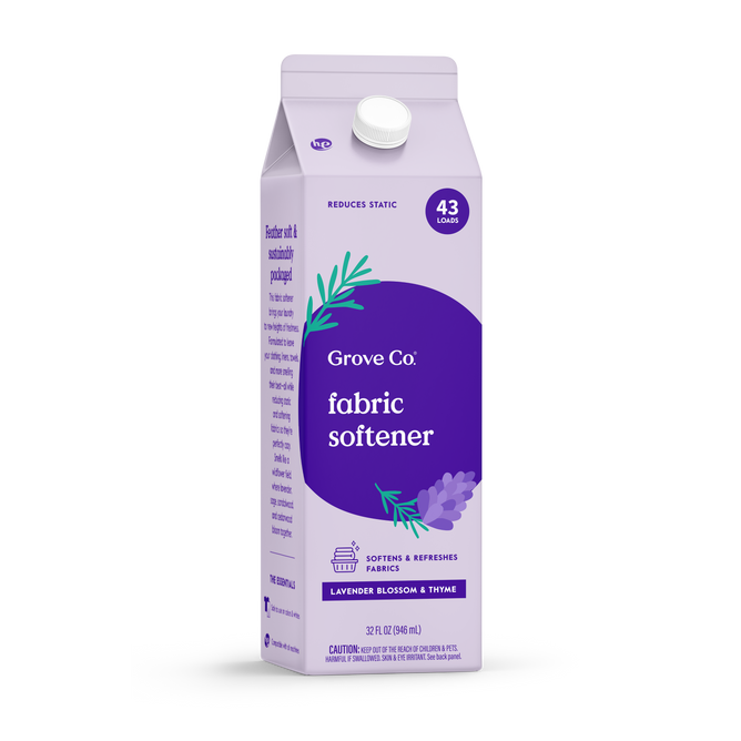 A 32 oz Grove Co. Liquid Fabric Softener in Lavender Blossom & Thyme scent, labeled for 43 loads, features lavender graphics and promotes static reduction and fabric softening—pairs well with a reusable silicone laundry cup.