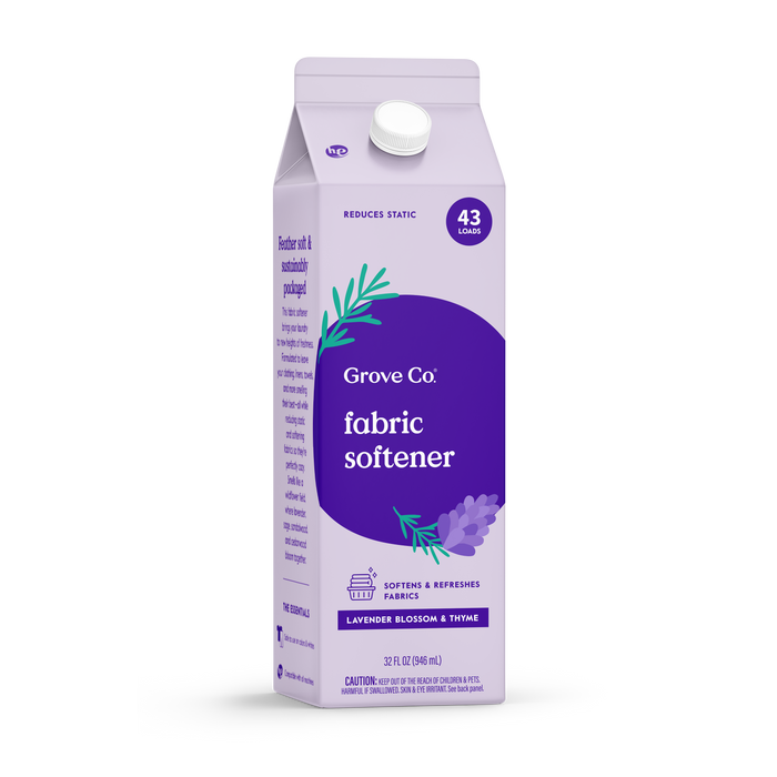A 32 oz Grove Co. Liquid Fabric Softener in Lavender Blossom & Thyme scent, labeled for 43 loads, features lavender graphics and promotes static reduction and fabric softening—pairs well with a reusable silicone laundry cup.