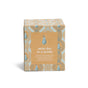 A brown box with a blue and gold geometric pattern features a pear illustration and the phrase “snow day in a bottle.” Part of Grove Co.’s Winter Collection, this Soy Wax Blend Candle offers a natural origin fragrance.