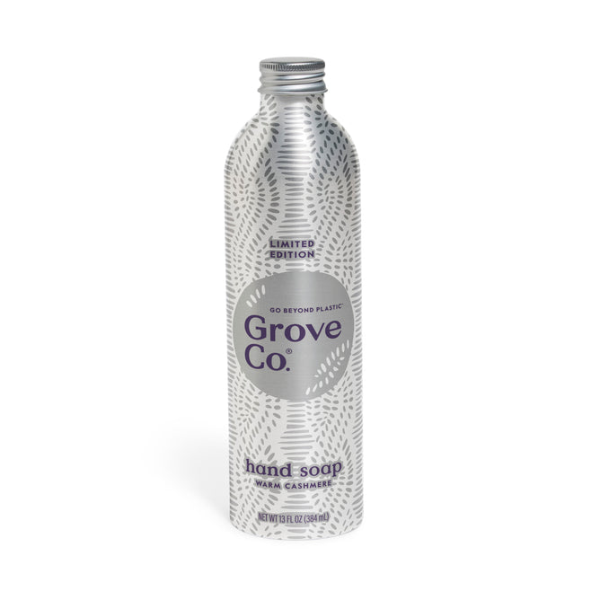 A silver aluminum 16 fl oz Grove Co. Hand Soap Refill from the Winter Collection features plant-based ingredients, a natural origin scent, subtle white leaf design, screw cap, and Limited Edition Warm Cashmere fragrance.
