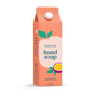A juice box-shaped coral carton, labeled Grove Collaborative Grove Co. Hand Soap – Hydrates & Moisturizes With Every Wash in passionfruit & white peach, features fruit art, a white cap, and offers a fresh, natural scent.