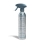 A silver spray bottle with a blue trigger, labeled Grove Co. Multi-Purpose Cleaner - Winter Collection, stands upright on a white background. Blue and white designs evoke a cool, wintry feel.