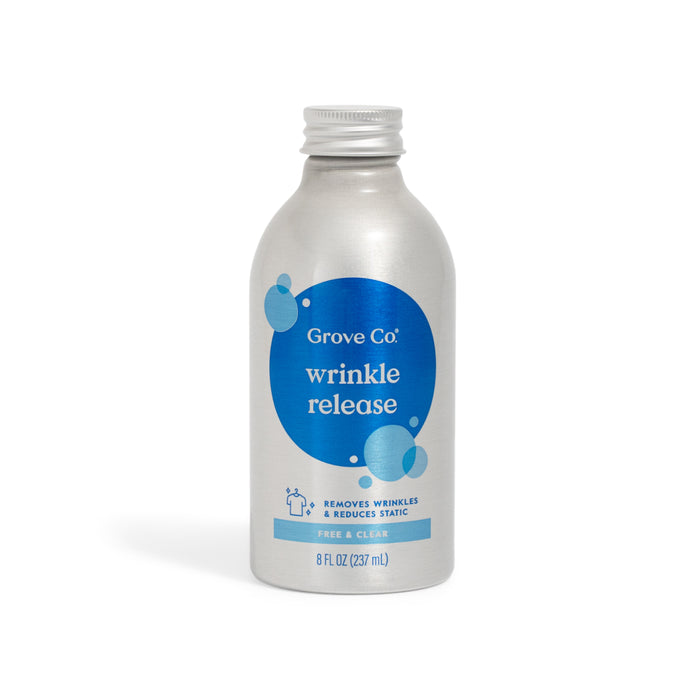 A silver 8 fl oz (237 ml) bottle of Grove Co. Wrinkle Release Refill – No Iron Needed, Just Spray And Hang, an eco-friendly laundry spray labeled Free & Clear with a blue circular bubble design, removes wrinkles and reduces static.