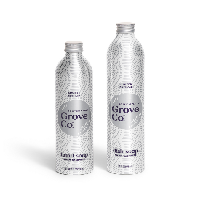 Two metallic Grove Co. Scents & Suds - Winter Collection bottles with a gray leaf pattern: hand soap on the left and dish soap on the right, both labeled “Warm Cashmere” and “Limited Edition.”.