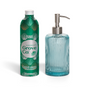 A Grove Co. Hand Soap Starter Set - Winter Collection sits beside a ribbed glass soap dispenser with a metal pump, filled with blue liquid.