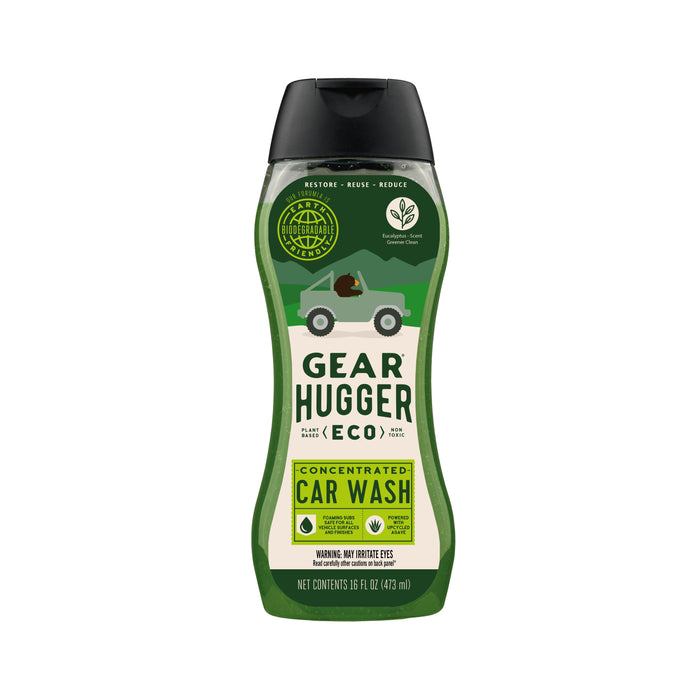 The 16 oz (473 ml) Gear Hugger Eco Car Wash bottle features eco-friendly icons and green vehicle graphics, emphasizing its bio-based ingredients and environmental benefits, along with usage instructions for its concentrated formula.