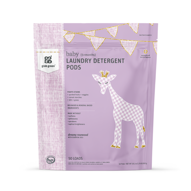 A pastel purple bag of grab green Baby Laundry Detergent Pods (5+ Months) features a giraffe and gold bunting, highlights the “dreamy rosewood” scent, is vegan, and suitable for babies 5+ months.