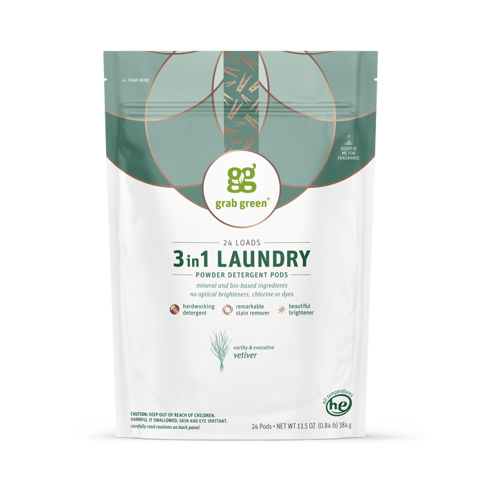 A white pouch of grab green 3 in 1 Laundry Detergent Pods - Vetiver, with green and gold accents, delivers 24 loads with its concentrated formula, mineral and bio-based ingredients, built-in stain remover, and eco-friendly features.