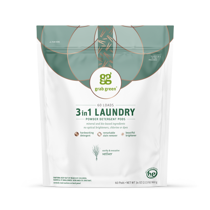 A white and green bag of grab green 3 in 1 Laundry Detergent Pods in Vetiver scent covers 60 loads; features natural ingredients, no optical brighteners, biodegradable pods, and delivers strong stain removal.