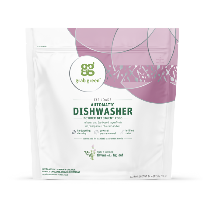 A white and pink grab green pouch of Automatic Dishwasher Detergent Pods in Thyme with Fig Leaf scent, labeled for 132 loads, features eco-friendly claims, promises spot-free dishes, and has abstract pink/green circular designs on top.