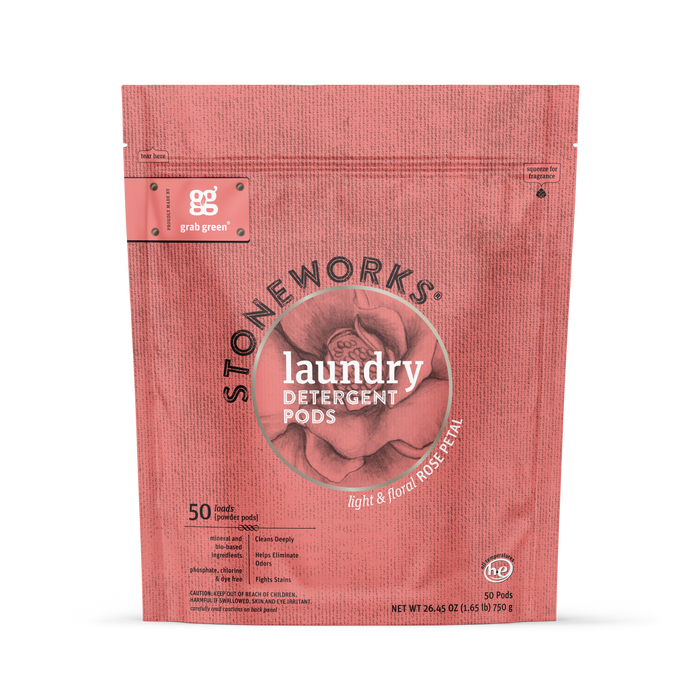 A pink grab green Stoneworks Laundry Detergent Pods - Rose Petal bag with a floral design contains 50 pods, labeled “light & floral,” and is formulated to neutralize odors for naturally clean clothes.