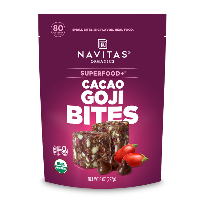 A purple pouch of Navitas Organics Superfood+ Cacao Goji BITES showcases two bite-sized, gluten-free, nutrient-rich treats with nuts, seeds, and goji berries—organic chocolate bites packed with superfoods.