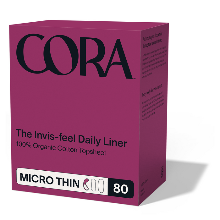 A purple box featuring the Cora logo prominently at the top displays Cora Invisi-feel Daily Liner, Micro Thin, with text highlighting “100% Organic Cotton Topsheet,” “MICRO THIN,” and “80.” The packaging emphasizes these hypoallergenic liners designed for comfortable daily freshness.