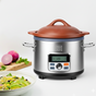 The VitaClay® Chef VITACLAY NourishingPot™- VM1688-9, featuring a natural clay lid, sits beside a bowl of salad and chopped vegetables on a wooden board against a plain white background.