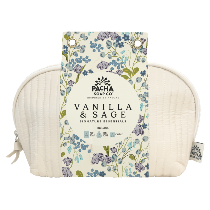 A cream quilted pouch with a floral tag labeled Self Care Spa Set - Vanilla & Sage by Pacha Soap Co. features soothing blue, green, and purple blooms and includes a soap, bath bomb, and candle.