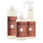 A dish soap bottle, a pump bottle of hand soap, and a spray bottle of multi-surface cleaner, all featuring gingerbread-scented labels as part of this Mrs. Meyer’s Holiday Cleaning Set – Home Essentials.