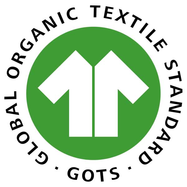 The GOTS logo featuring a white upward arrow shaped like a T-shirt on a green circle, surrounded by the words “GLOBAL ORGANIC TEXTILE STANDARD • GOTS” in black, capital letters.