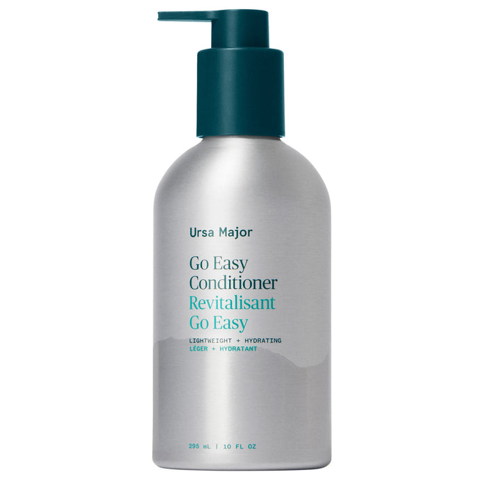 A 236 ml (8 fl oz) silver bottle with a teal pump labeled Ursa Major Go Easy Conditioner, a lightweight, hydrating conditioner for added shine and volume.