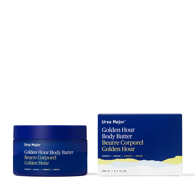 Ursa Major Golden Hour Body Butter comes in a blue jar with matching box, featuring white and gold minimalist text—perfect for deep hydration and restoring your skin barrier.