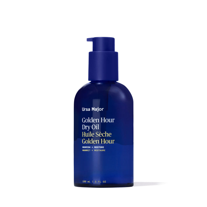 Ursa Major Golden Hour Dry Oil is a blue 150 ml (5 fl oz) bottle with a pump and white text, designed to replenish skin and hair while locking in moisture for long-lasting nourishment.