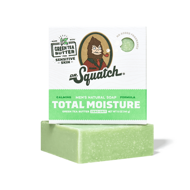 Dr. Squatch Men's Total Moisture Soap is a green bar for sensitive skin, made with natural butters and green tea butter. The packaging has a Sasquatch cartoon and notes "calming" and "no added fragrances.