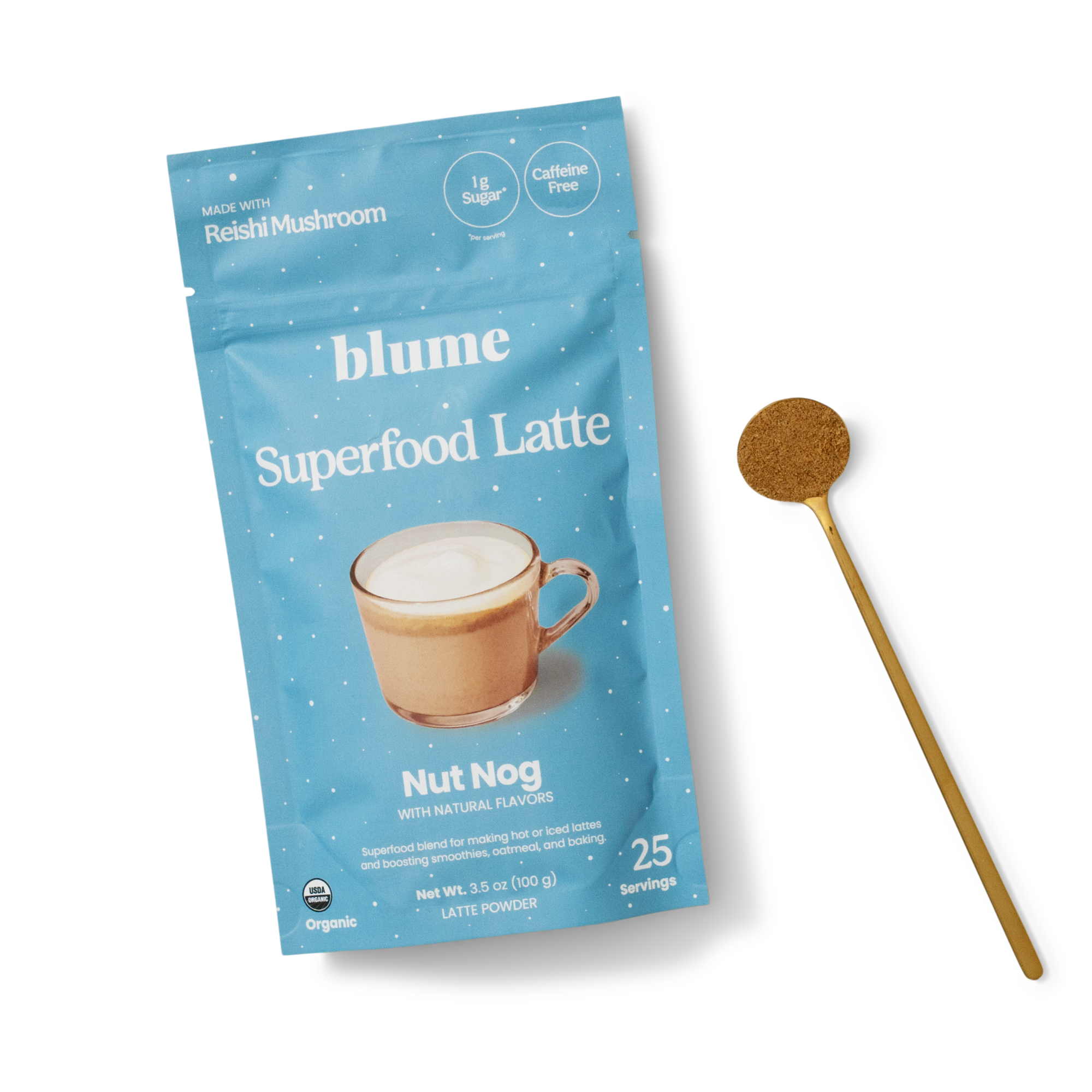 A blue packet of Blume Superfood Latte Nut Nog flavor lies next to a golden spoon with powder. The packet mentions it contains reishi mushroom, is caffeine free, has 1g sugar, and makes 25 servings.