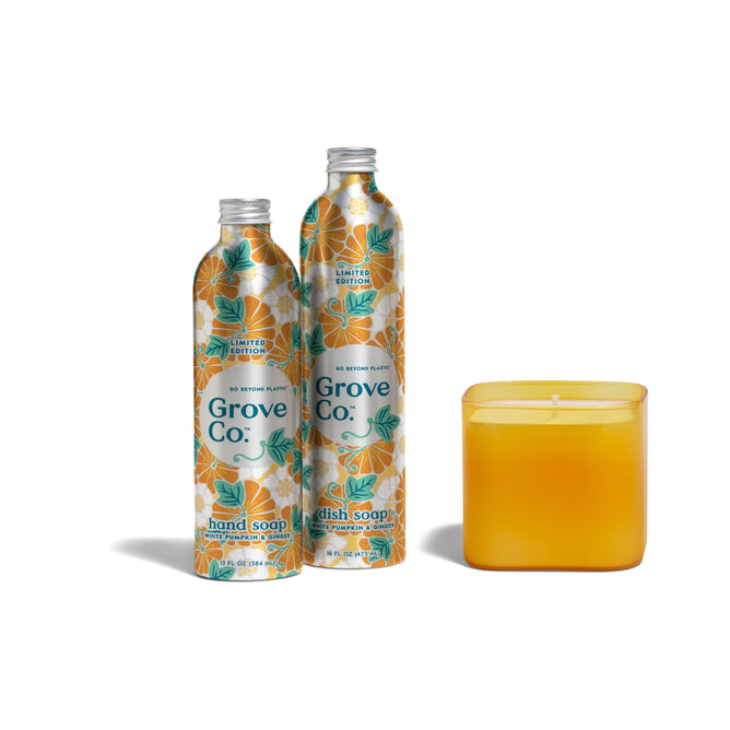 Three items from the Grove Co. Fall Trio Set—hand soap, dish soap in floral-patterned bottles, and a square yellow-orange candle in a glass container—are arranged together on a white background.