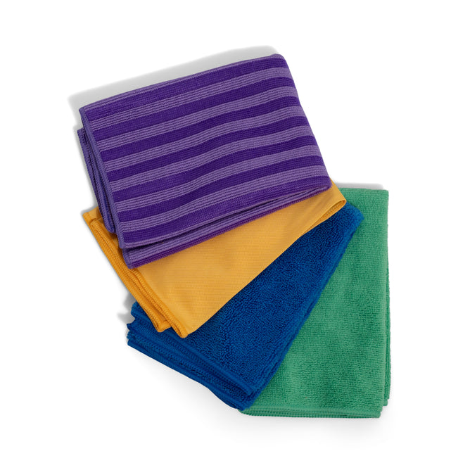 Grove Co. Assorted Cleaning Cloths, 4 pk—machine-washable microfiber in purple with stripes, yellow, blue, and green—are shown stacked on a white background for sustainable cleaning.