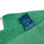 A close-up of a green Grove Co. Assorted Cleaning Cloth from the 4 pk set, with a blue “All-Purpose Microfiber” tag and three sparkling stars, highlights this top machine-washable, sustainable cleaning product for your home.