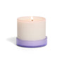 The Grove Co. Candle - 7oz features a lit white candle in a round container with a translucent purple base, displayed against a plain white background.