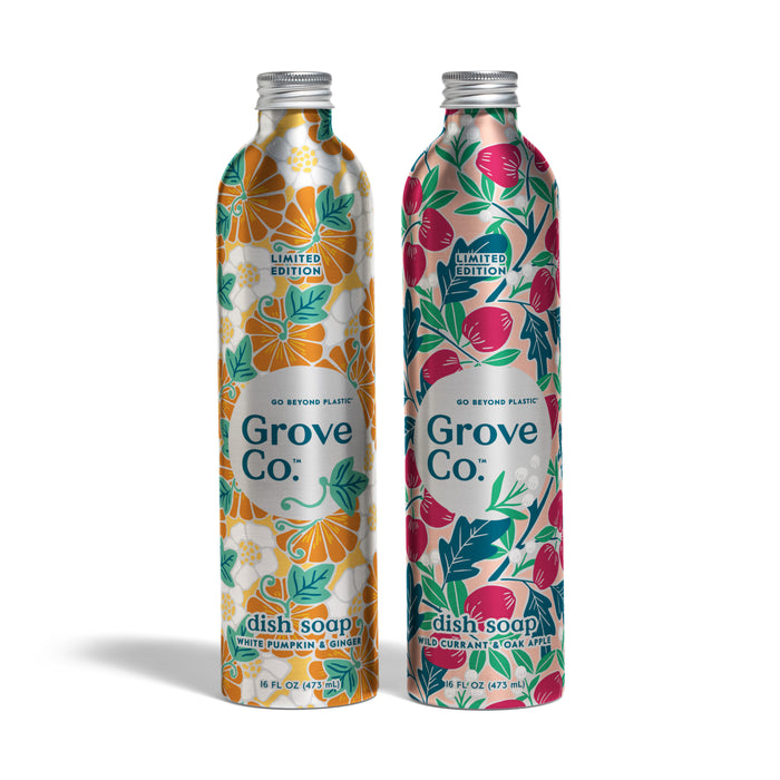 Two sustainable metallic bottles of Grove Co. Dish Soap Set - Fall Collection with floral designs stand side by side: orange and white on the left, pink and green on the right. Limited edition.