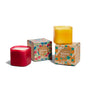The Grove Co. Candle Set - Fall Collection features two eco-friendly square candles, one red and one yellow, with decorative boxes adorned in colorful floral designs—perfect for adding seasonal charm to your home.