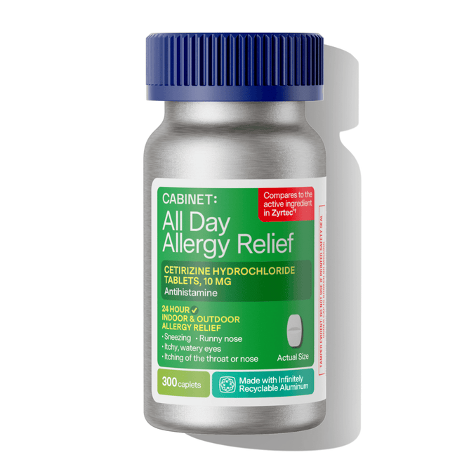 A bottle of Cabinet Health All Day Allergy Relief Caplets contains 300 non-drowsy caplets with 10 mg cetirizine hydrochloride each, offering 24-hour indoor and outdoor allergy relief in recyclable aluminum packaging.