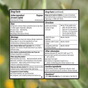 A close-up of the drug facts label for Cabinet Health All Day Allergy Relief Caplets, highlighting Cetirizine HCl 10mg as the active ingredient, and presenting information on usage, warnings, directions, storage instructions, and a customer service phone number—all displayed against a blurred green background.