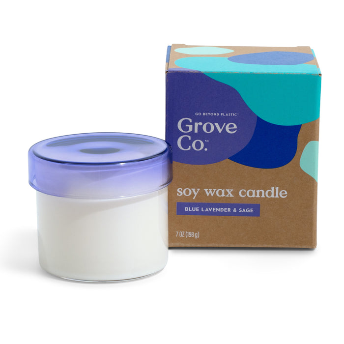 A white Grove Co. Soy Wax Candle – 30+ Hours of Burn Time with natural fragrances sits in a reusable glass jar with a lavender lid, next to its brown and blue box labeled blue lavender & sage, 7 oz (198 g).