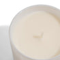 A close-up of the Grove Co. Soy Wax Candle – 30+ Hours of Burn Time, showing its smooth white soy wax in a reusable glass jar and a centered wick.
