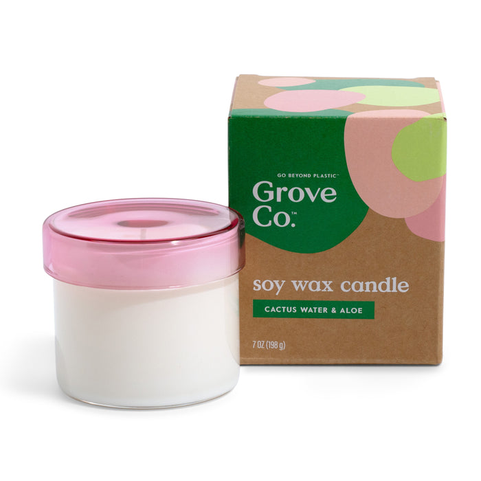 A white soy wax candle by Grove Co., featuring over 30 hours of burn time, comes in a reusable glass jar with a pink lid beside its brown and green box, labeled Cactus Water & Aloe, 7 oz (198 g), made with natural origin fragrances.