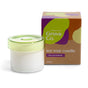 A white soy wax candle by Grove Co. in a reusable glass jar with a light green lid sits beside its colorful box labeled 
