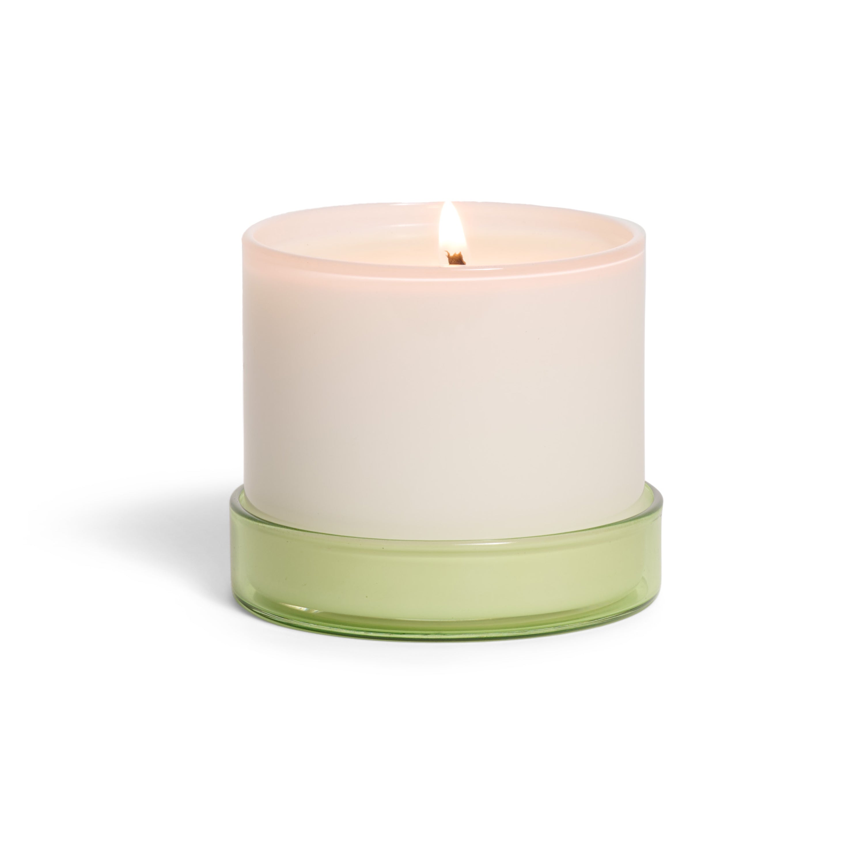 The Grove Co. Candle - 7oz is a lit white candle in a simple opaque container with a light green glass base, displayed against a white background.