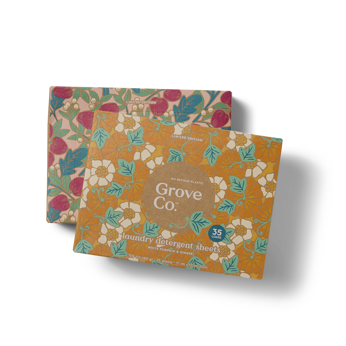 Two boxes of Grove Co. laundry detergent sheets with colorful floral patterns on the packaging. One box is mainly orange with white flowers, and the other has a red and green floral design.